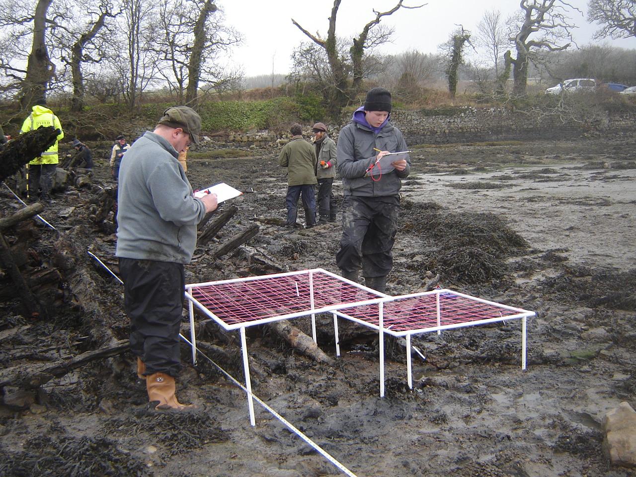 Volunteers from the Dyfed Archaeological Trust carrying out Planning Frame exercises on the wreck of the Helping Hand at Lawrenny